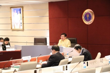 A group of people sitting at a desk Description automatically generated