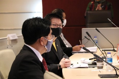 A person sitting at a table using a computer Description automatically generated