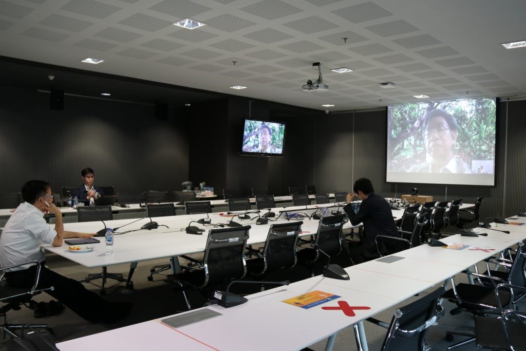 A group of people sitting at a desk Description automatically generated