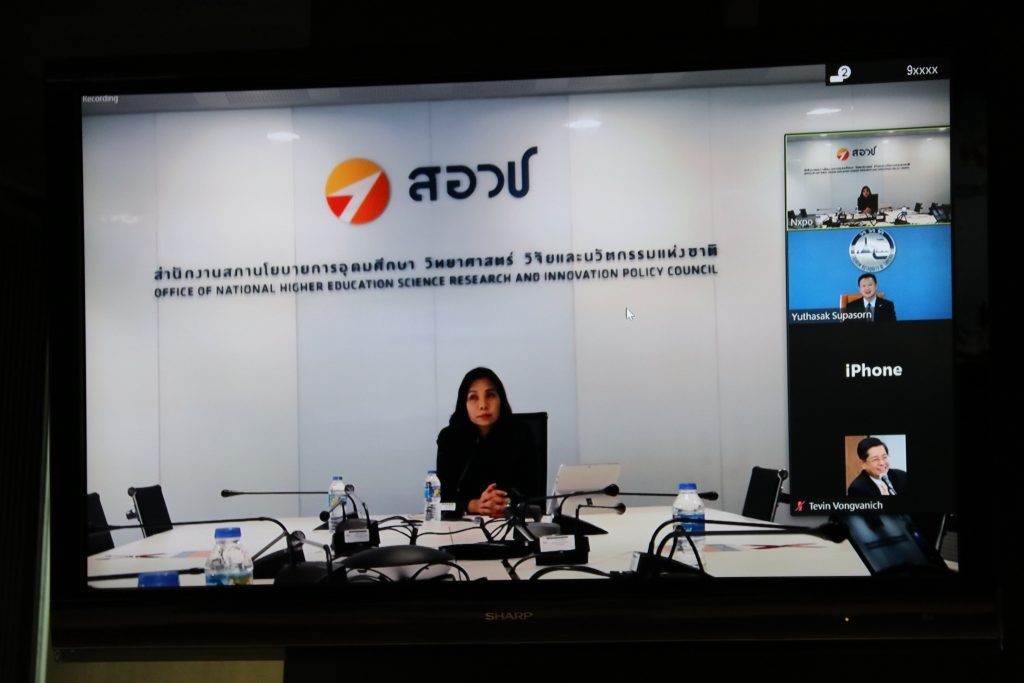A person standing in front of a computer screen Description automatically generated