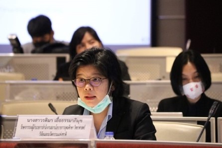 A person sitting at a table Description automatically generated