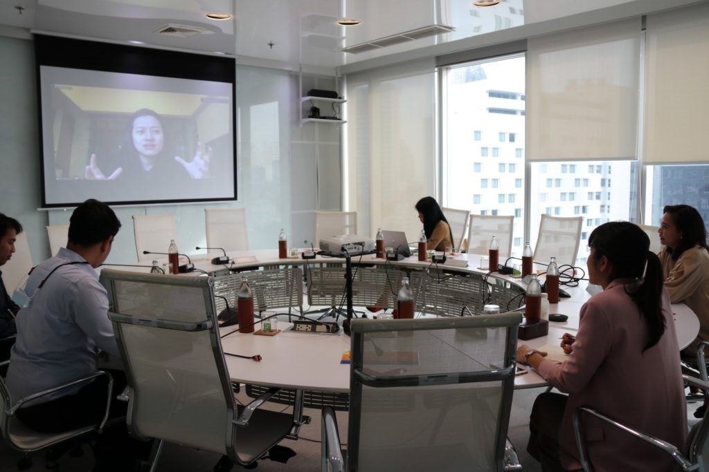 A group of people in a meeting Description automatically generated with medium confidence